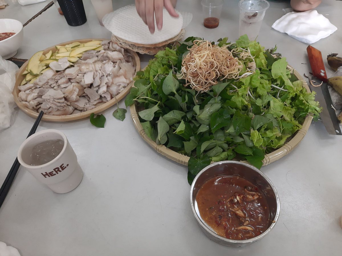 Rice paper, pork and herbs laid out for banh trang cuon thit heo
