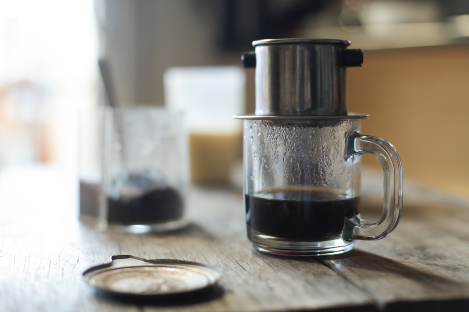 Vietnamese coffee dripping through a phin filter